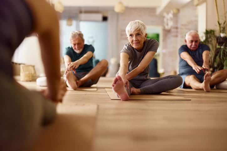 Seniors Doing Yoga Together In A Class.